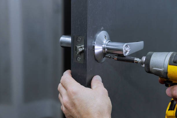 Professional locksmith from ReKey Xpress using specialized tools to open a locked front door during an emergency.